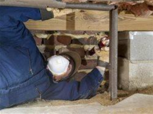 Image of a man installing DIY insulation in a crawl space.